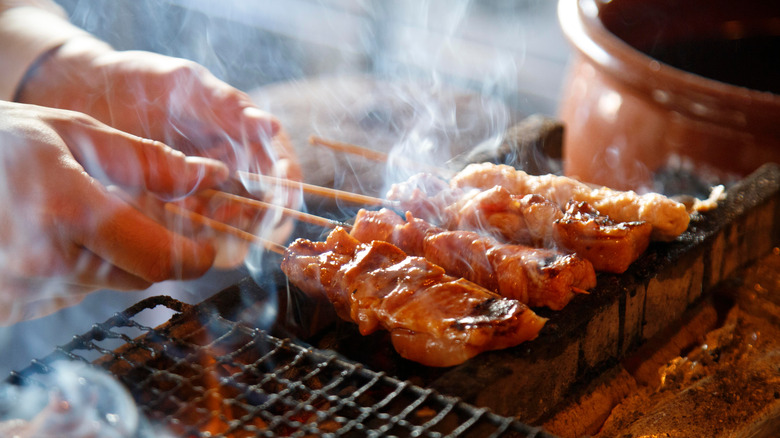 chicken skewers cooking on grill