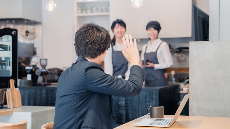 man calling waiter Japanese restaurant