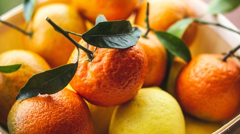 Orange and yellow citrus fruits in a basket 