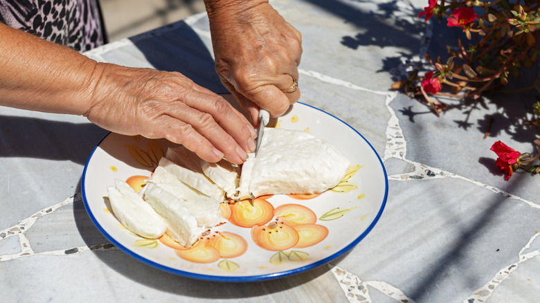 Slicing fresh halloumi cheese