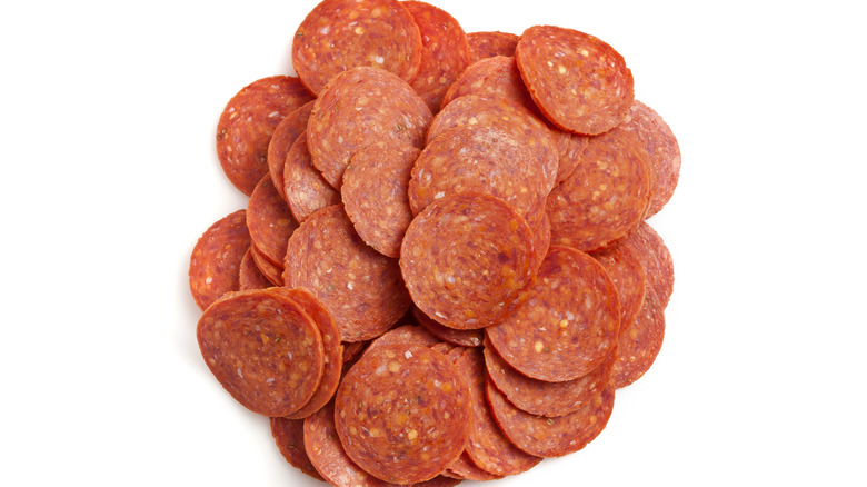 pile of pepperoni on white background