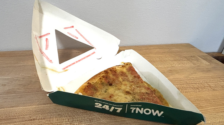 Cheese slice from 7-Eleven on cutting board