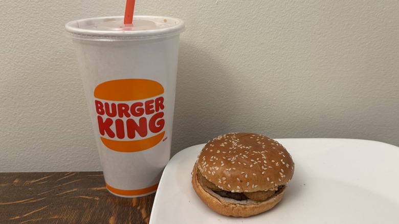 Rodeo Burger on plate next to Burger King soft drink