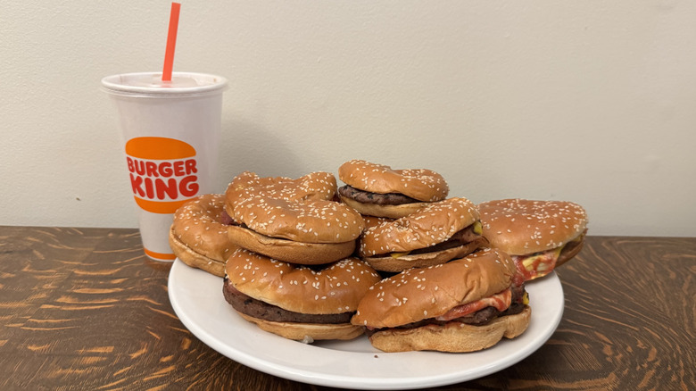Stack of Burger King burgers on plate with Burger King soft drink