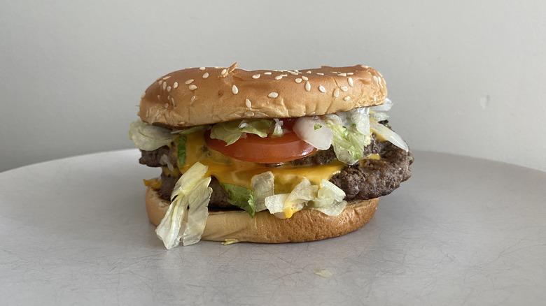 McDonald's Double Quarter Pounder with Cheese Deluxe sitting on a plate