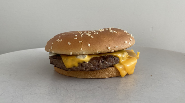 McDonald's Quarter Pounder with Cheese sitting on a plate