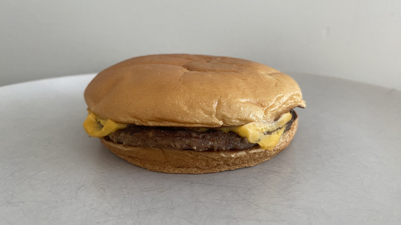 McDonald's Cheeseburger sitting on a plate