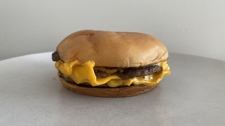McDonald's Triple Cheeseburger sitting on a plate