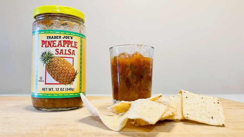 Jar and dish of Trader Joe's Pineapple Salsa with tortilla chips