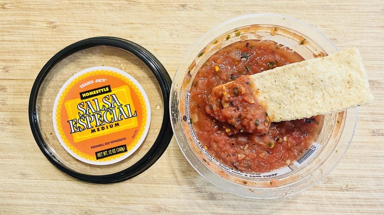 Overhead view of opened container of Trader Joe's Medium Salsa Especial with chip