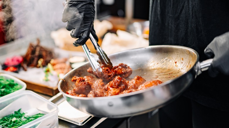 chicken wings in frying pan