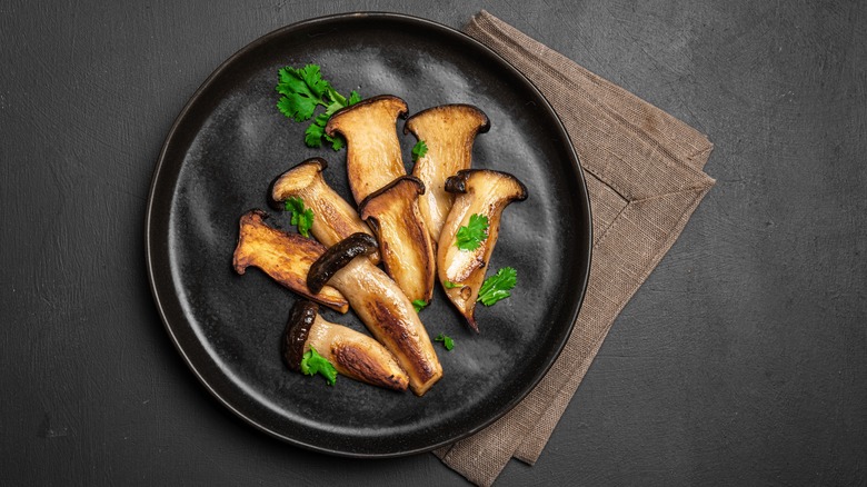 King oyster mushroom plated on black background