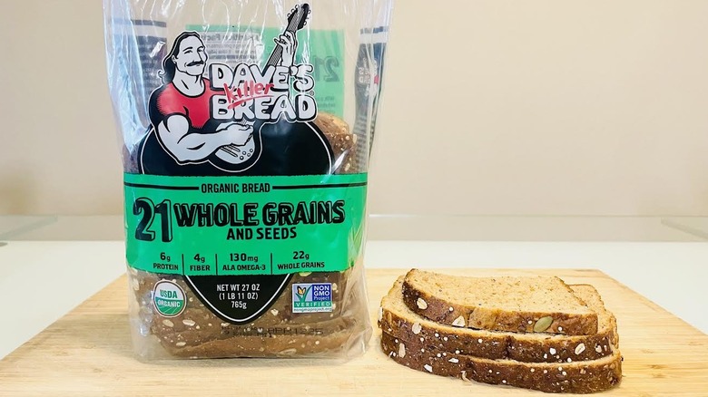 Loaf of Dave's Killer Organic 21 Whole Grains and Seeds Bread with slices on side