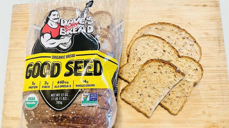Loaf of Dave's Killer Good Seed Bread with slices on side