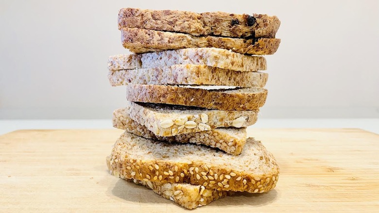 Stack of various flavors of sliced Ezekiel Bread