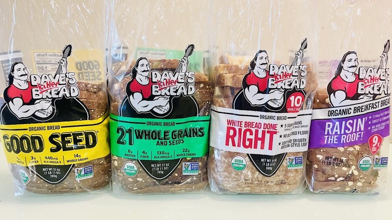 Four loaves of Dave's Killer bread in upright packaging