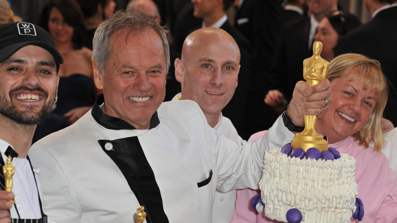 Wolfgang Puck holding an Academy Award cake