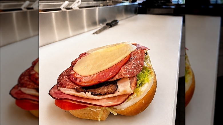 An open Jimmy John's The J.J. Gargantuan sandwich sits on a food prep counter