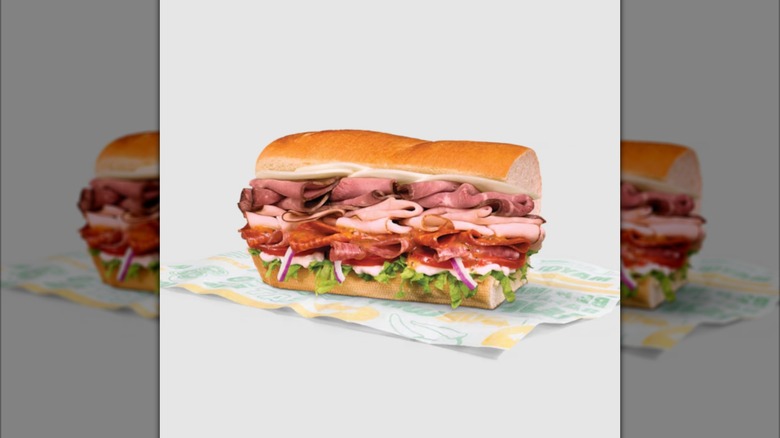A Subway 5 Meat Italian sandwich sits on a paper wrapper.