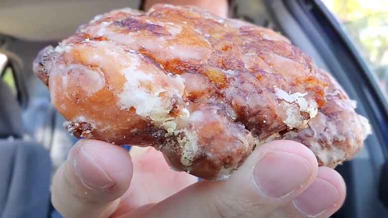 Hand holding a discontinued Apple Fritter from the McCafé menu