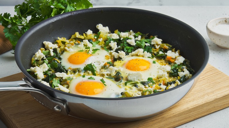 fried eggs with feta cheese and herbs