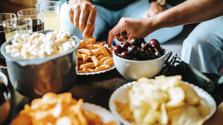 People eating snacks on table