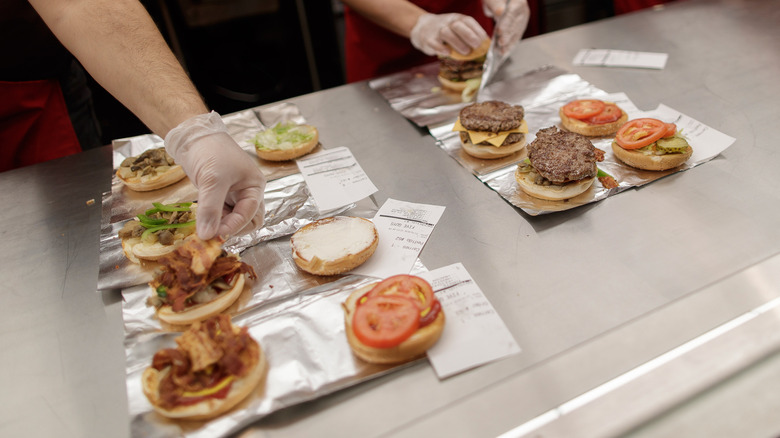 Five Guys workers assembling burgers.