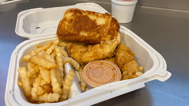A three-piece dinner sits in an open to-go box at Raising Cane's