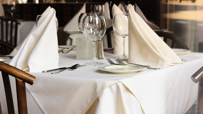 elaborately folded napkins at dinner table