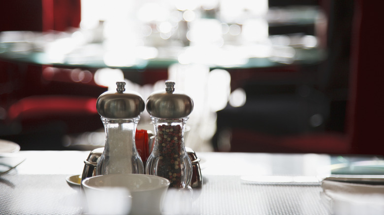 salt and pepper mills on table