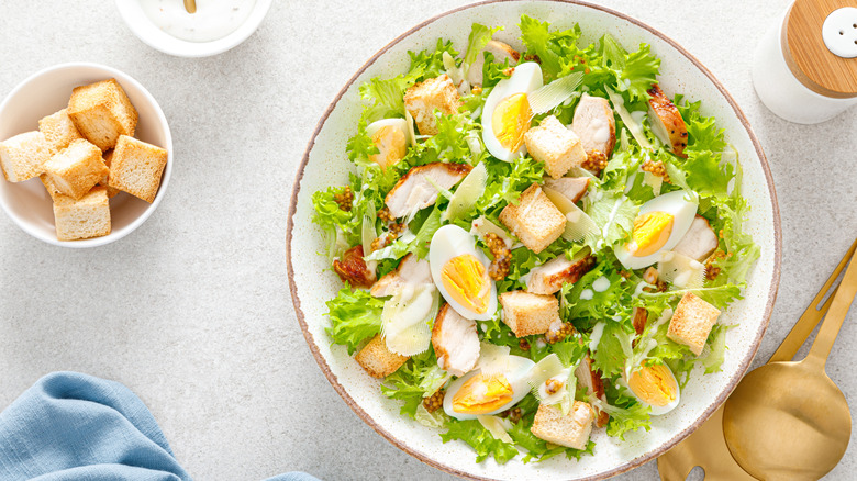 Chicken caesar salad with croutons and egg