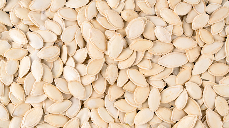 Pumpkin seeds sit in a pile.