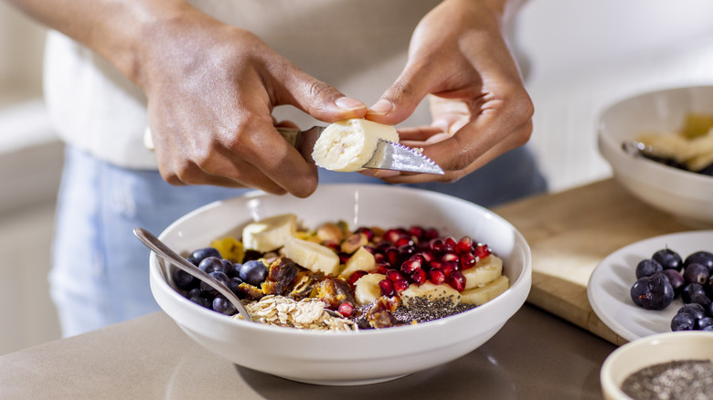 bowl of oats with banana, blueberries, pomegranites, and chia seeds