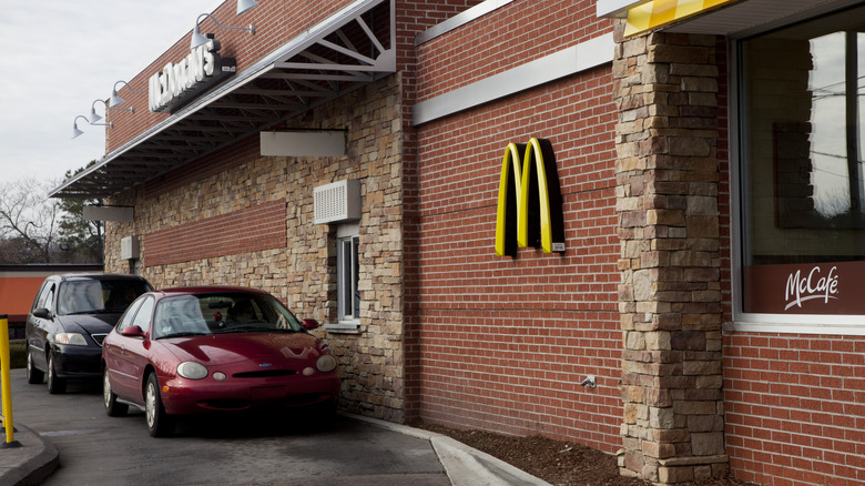 Cars sit in the drive-thru of a McDonald's.