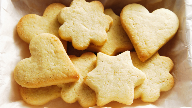 shortbread cut cookies in hearts, flowers, and magen david shapes sit in a box