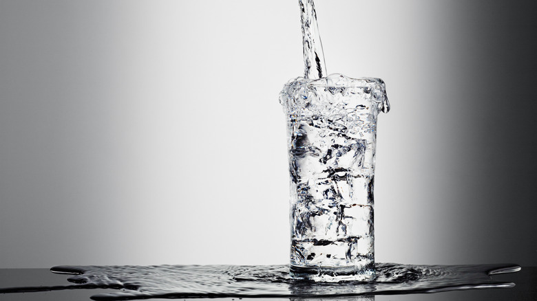 An overflowing glass of water