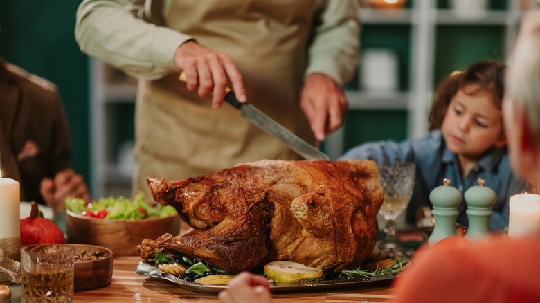 A turkey being carved on a table.