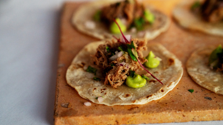 Pork tacos on wooden board