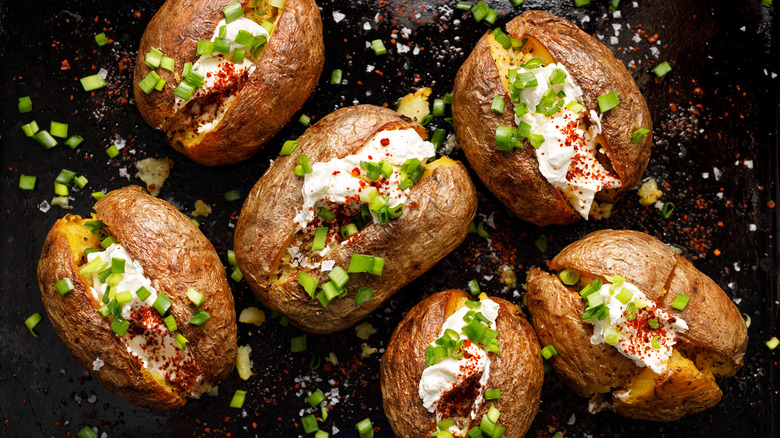 Baked potatoes with crisp skin stuffed with cream cheese and chives