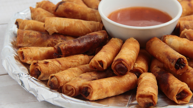 Batch of lumpia served with sauce
