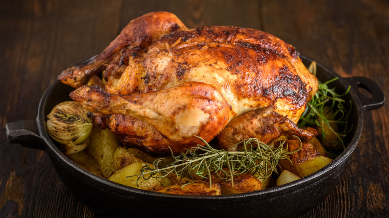 a roasted chicken with potatoes