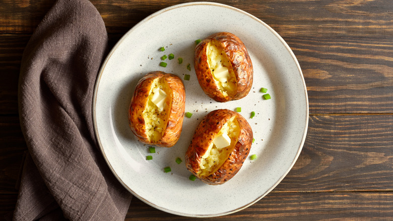 baked potatoes sliced on plate