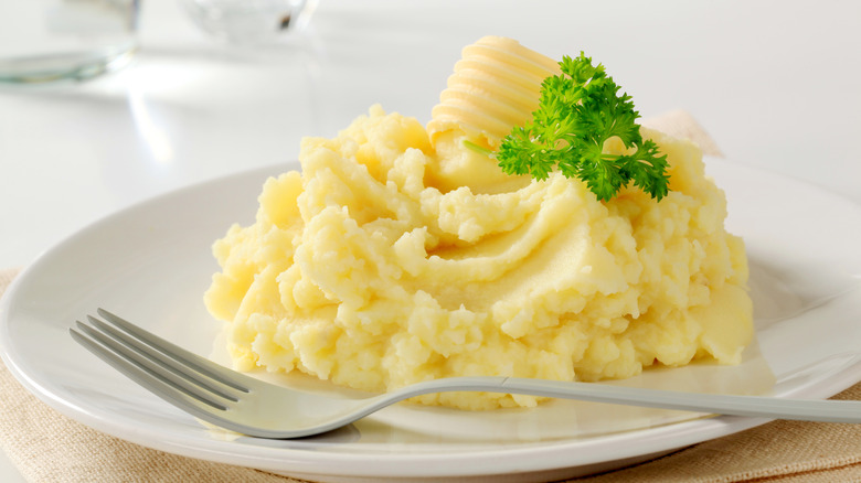 Serving of mashed potatoes with fork