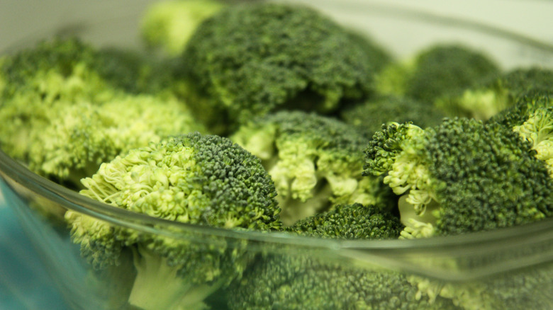 Closeup of broccoli florets sitting in a glass bowl
