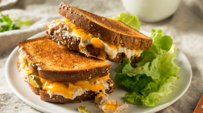 Cheesy tuna melt sandwich on plate with lettuce