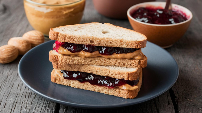 A peanut butter and jelly sandwich sits on a plate.