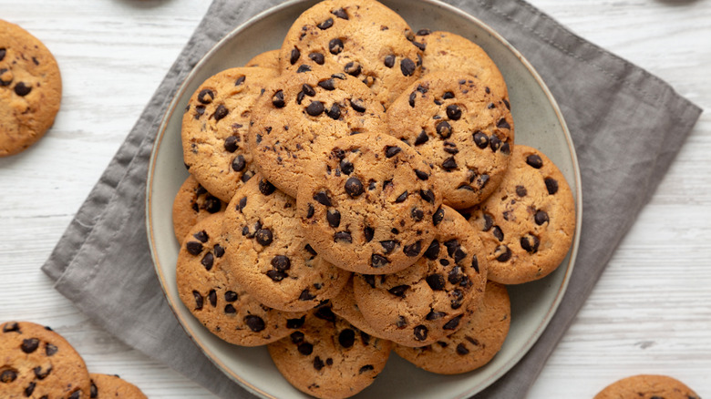 A batch of chocolate chip cookies on a plate.