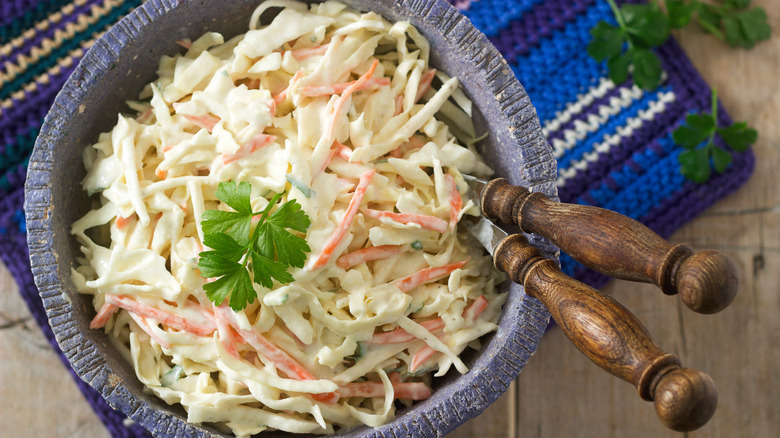 Coleslaw with carrots in a blue stone bowl