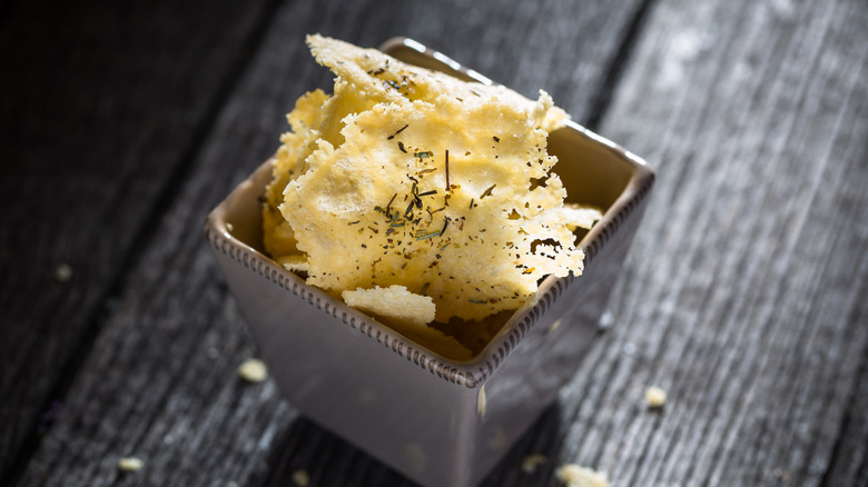 A small ramekin of parmesan crisps