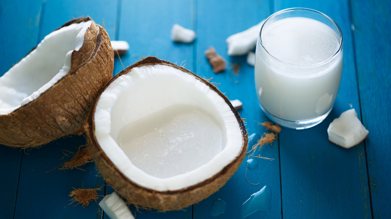 Cracked coconuts alongside coconut milk.